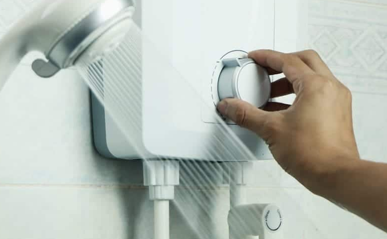 hand adjusting tankless water heater in shower