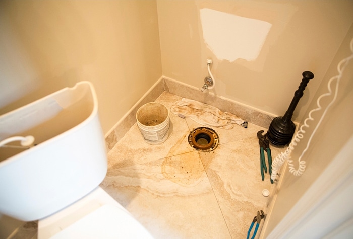 A toilet being dismantled and reassembled.